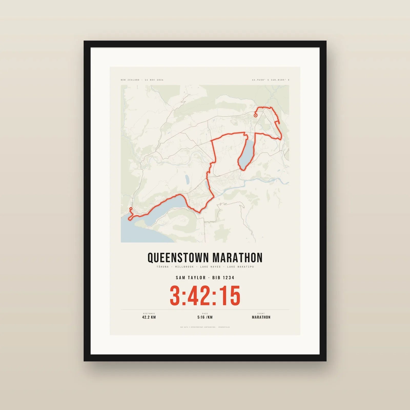 A framed Queenstown Marathon poster in the Paper colourway hanging on a wall